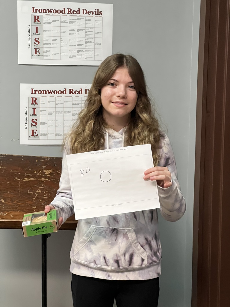 Riley DeTray holds a picture of a well drawn circle and an apple pie