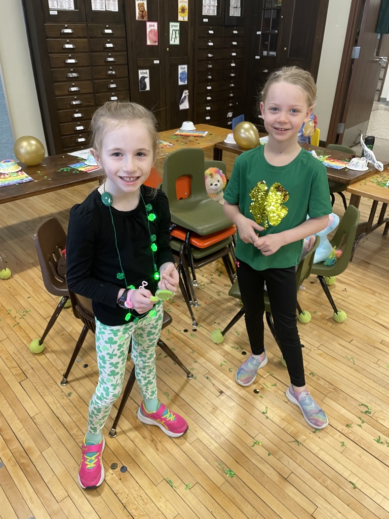 Two students dressed in green 
