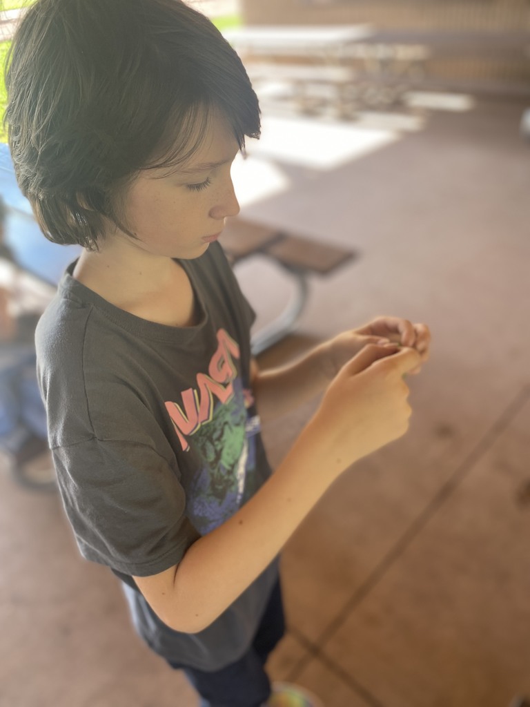A kid looks at his hands