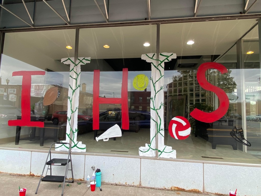 The letters IHS painted on a store window